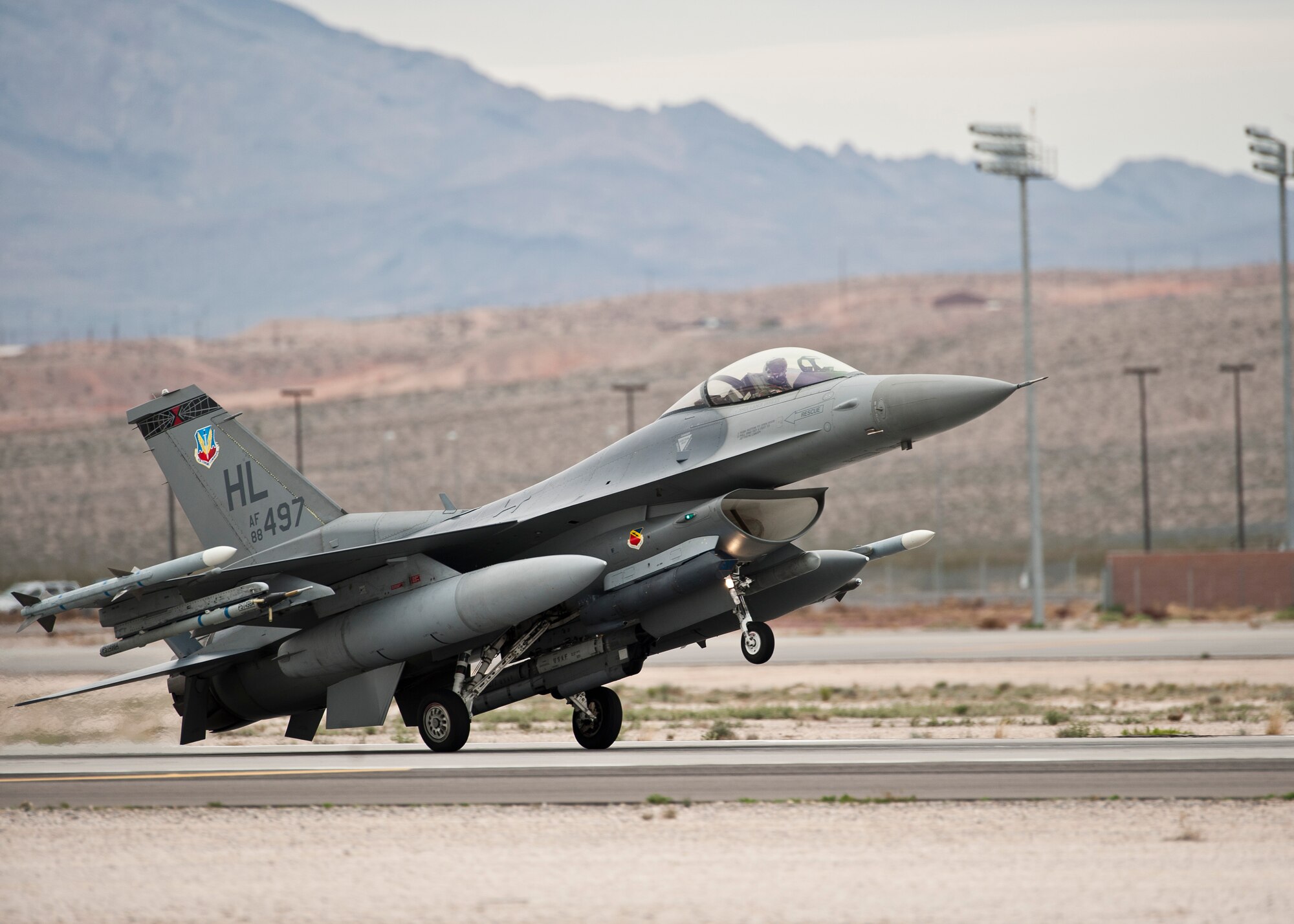 An F-16 Fighting Falcon assigned to the 421st Fighter Squadron, Hill Air Force Base, Utah, lands after a Red Flag 15-2 sortie at Nellis AFB, Nev., March 11, 2015. Red Flag provides a series of intense air-to-air scenarios for aircrew and ground personnel to increase their combat readiness and effectiveness for future real-world operations. (U.S. Air Force photo by Staff Sgt. Siuta B. Ika)