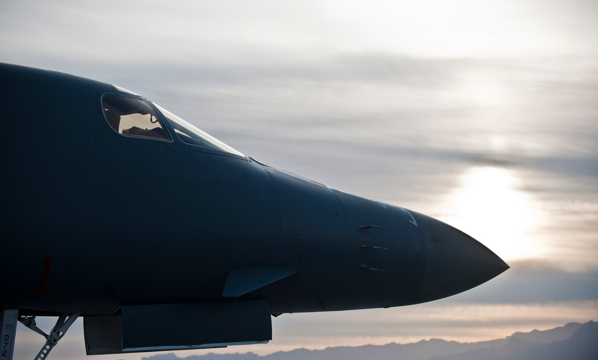 A B-1B Lancer assigned to the 37th Bomb Squadron, Ellsworth Air Force Base, S.D., sits on the tarmac as the sun sets during Red Flag 15-2 at Nellis AFB, Nev., March 10, 2015. Red Flag involves a variety of attack, fighter, bomber, reconnaissance, electronic warfare, airlift support and search and rescue aircraft. (U.S. Air Force photo by Staff Sgt. Siuta B. Ika)