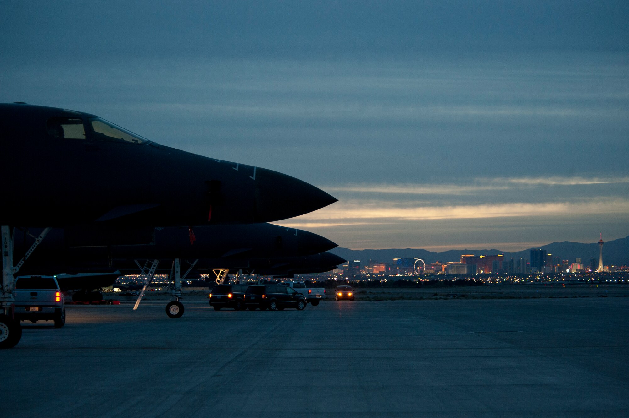 Three B-1B Lancers assigned to the 37th Bomb Squadron, Ellsworth Air Force Base, S.D., sit on the tarmac during Red Flag 15-2 at Nellis AFB, Nev., March 10, 2015. The B-1's blended body configuration, variable-geometry wings and turbofan afterburning engines combine to provide long range employment, maneuverability and high speed while enhancing survivability. (U.S. Air Force photo by Staff Sgt. Siuta B. Ika)