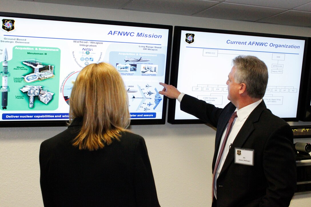 Steve Amburgey, Deputy Program Executive Officer for Strategic Systems, discusses an upcoming reorganization of the Air Force Nuclear Weapons Center with Secretary of the Air Force Deborah Lee James during her March 9 visit to Kirtland Air Force Base, N.M.  Strategic Systems is scheduled to merge with the Air Force Nuclear Weapons Center later this year in a move that will improve the life cycle management of nuclear weapons systems, allowing the center to sharpen their focus on acquisition and sustainment of nuclear weapon capabilities. (U.S. Air Force Photo by Meredith Mingledorff/Released)
