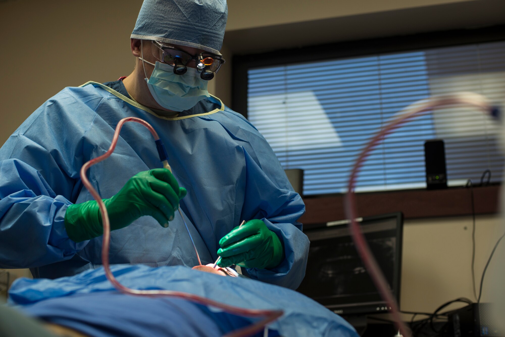 U.S. Air Force Capt. Jeremy Matis, 354th Dental Services Flight general dentist, performs oral surgery at Eielson Air Force Base, Alaska, Feb. 19, 2015. Wisdom teeth are located at the back of the mouth. They are difficult to reach to properly clean which can lead to infection and the need to remove them. (U.S. Air Force photo by Staff Sgt. Joshua Turner/Released)