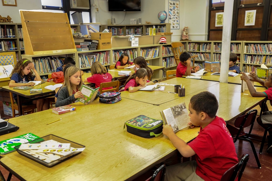 Hickam Elementary School students read in the library during the school’s annual Read Across America event at Joint Base Pearl Harbor-Hickam, Hawaii, March 6, 2015. The week-long event celebrates the life and contributions of Dr. Seuss, while also encouraging children and teens to read. (U.S. Air Force photo by Tech. Sgt. Terri Paden/RELEASED)