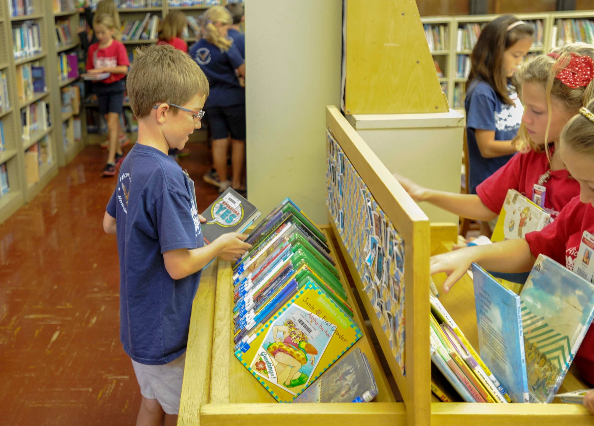 Ben Koening, 9, selects a book from the library at Hickam Elementary School during the school’s annual Read Across America event at Joint Base Pearl Harbor-Hickam, Hawaii, March 6, 2015. The week-long event celebrates the life and contributions of Dr. Seuss, while also encouraging children and teens to read. (U.S. Air Force photo by Tech. Sgt. Terri Paden/RELEASED)