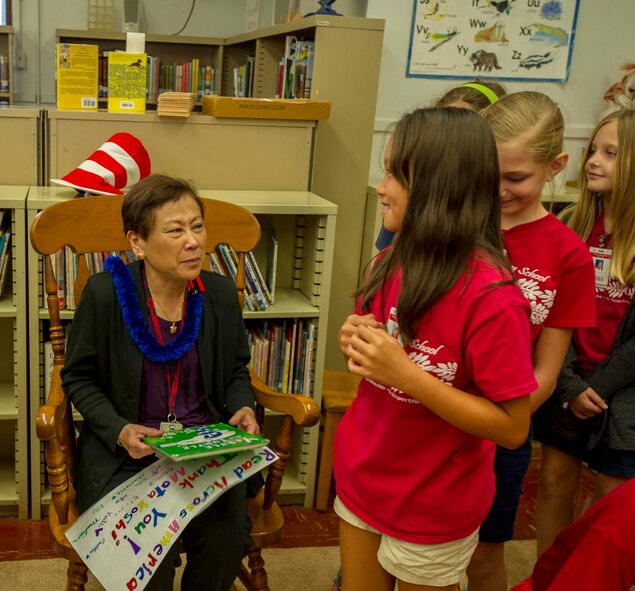 Kathryn Matayoshi, Hawaii superintendent of education, greets Hickam Elementary School students during the school’s annual Read Across America event at Joint Base Pearl Harbor-Hickam, Hawaii, March 6, 2015. Matayoshi participated as one of the guest speakers for the event, which celebrates the life and contributions of Dr. Seuss, while also encouraging children and teens to read. (U.S. Air Force photo by Tech. Sgt. Terri Paden/RELEASED)
