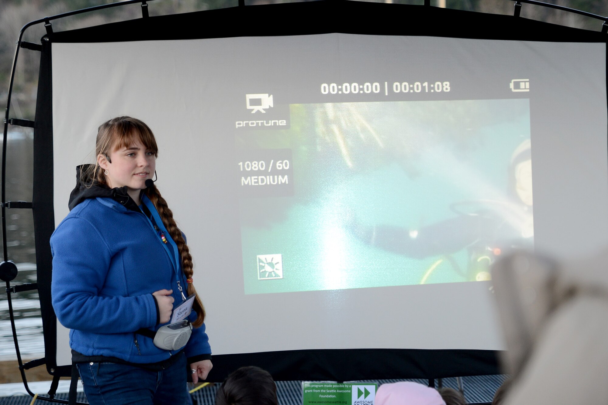 Stena Troyer, Harbor WildWatch science specialist, talks about the plants on a projector March 7, 2015, during Pier into the Night at Gig Harbor, Wash. The divers picked up crabs found in the water and showed some of the plants that thrive in the Puget Sound. (U.S. Air Force photo/Airman 1st Class Keoni Chavarria)