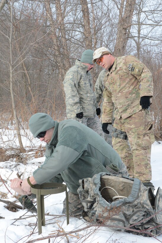 Senior Airman Joshua Wilcox, 115th Fighter Wing Explosive Ordnance Disposal, prepares the first explosive during a training exercise in Finley, Wis., March 6, 2015. The EOD team used the training exercise to allow the younger Airmen to experience setting up the explosives with minimal guidance from leadership. The EOD team used their training exercise to clear a waterway for the Juneau County Forestry Department, preventing possible floods in the local area. (U.S. Air National Guard photo by Senior Airman Andrea F. Rhode)