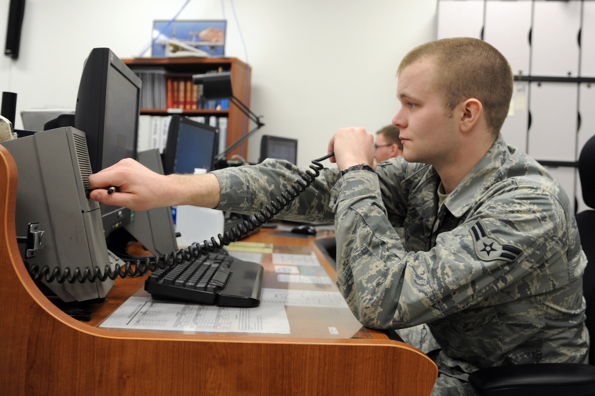 Airman 1st Class Anthony Kelly, 319th Communications Squadron High Freqency Global Communication System coordinator, works in the 319th CS building on Grand Forks Air Force Base, N.D., March 4, 2015. Kelly was selected as the Grand Forks AFB Warrior of the Week for the second week of March 2015. (U.S. Air Force photo/Staff Sgt. David Dobrydney)