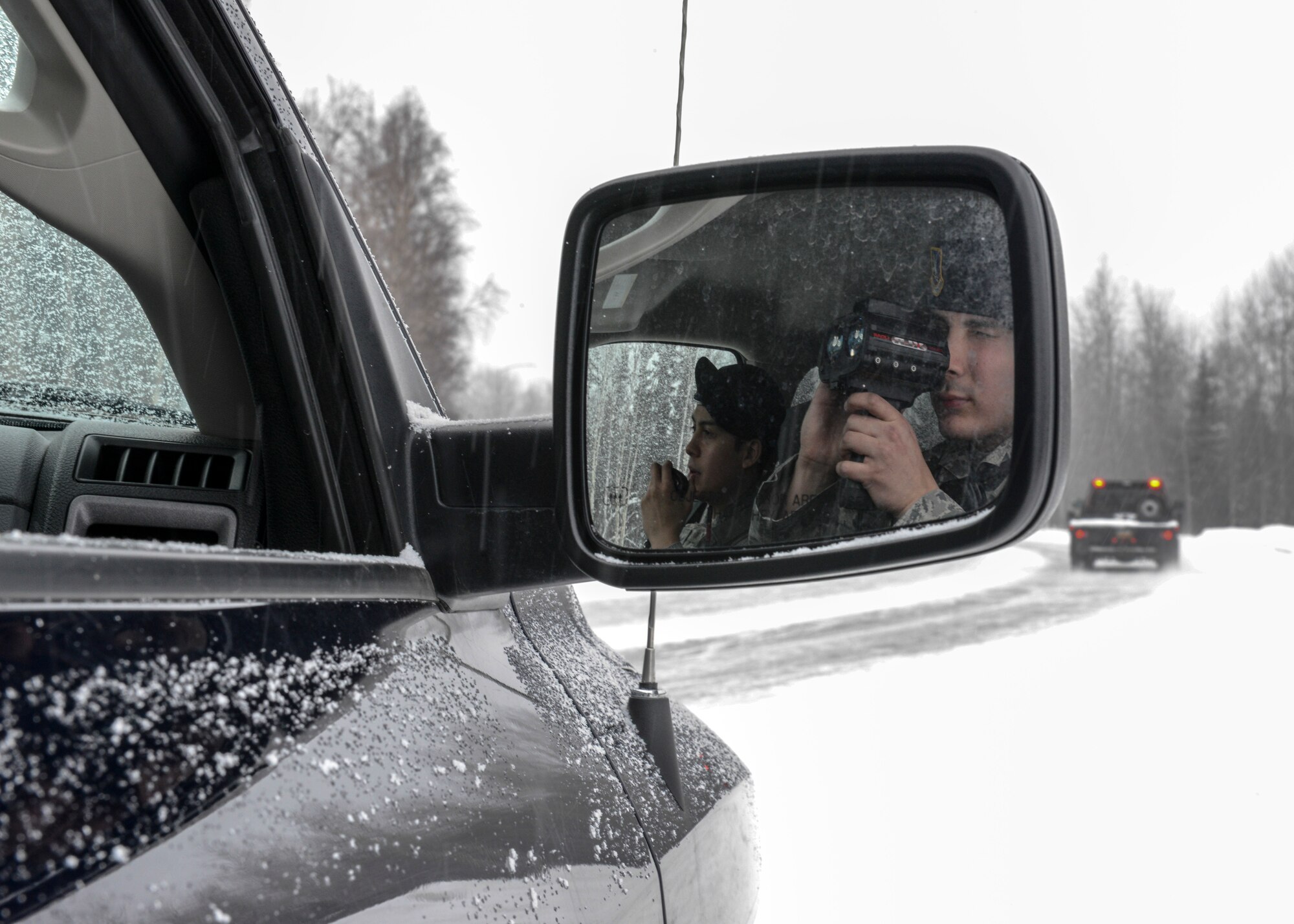 U.S. Air Force Senior Airman Patrick Shirley and Airman 1st Class Danny Banderas, 354th Security Forces Squadron response force leaders, check for speeders during a patrol March 3, 2015, Eielson Air Force Base, Alaska. During their off-time, Shirley and Banderas painted over 1,200 feet of the security forces building with a thin blue line to remember fallen defenders. (U.S. Air Force photo by Senior Airman Ashley Nicole Taylor/Released)