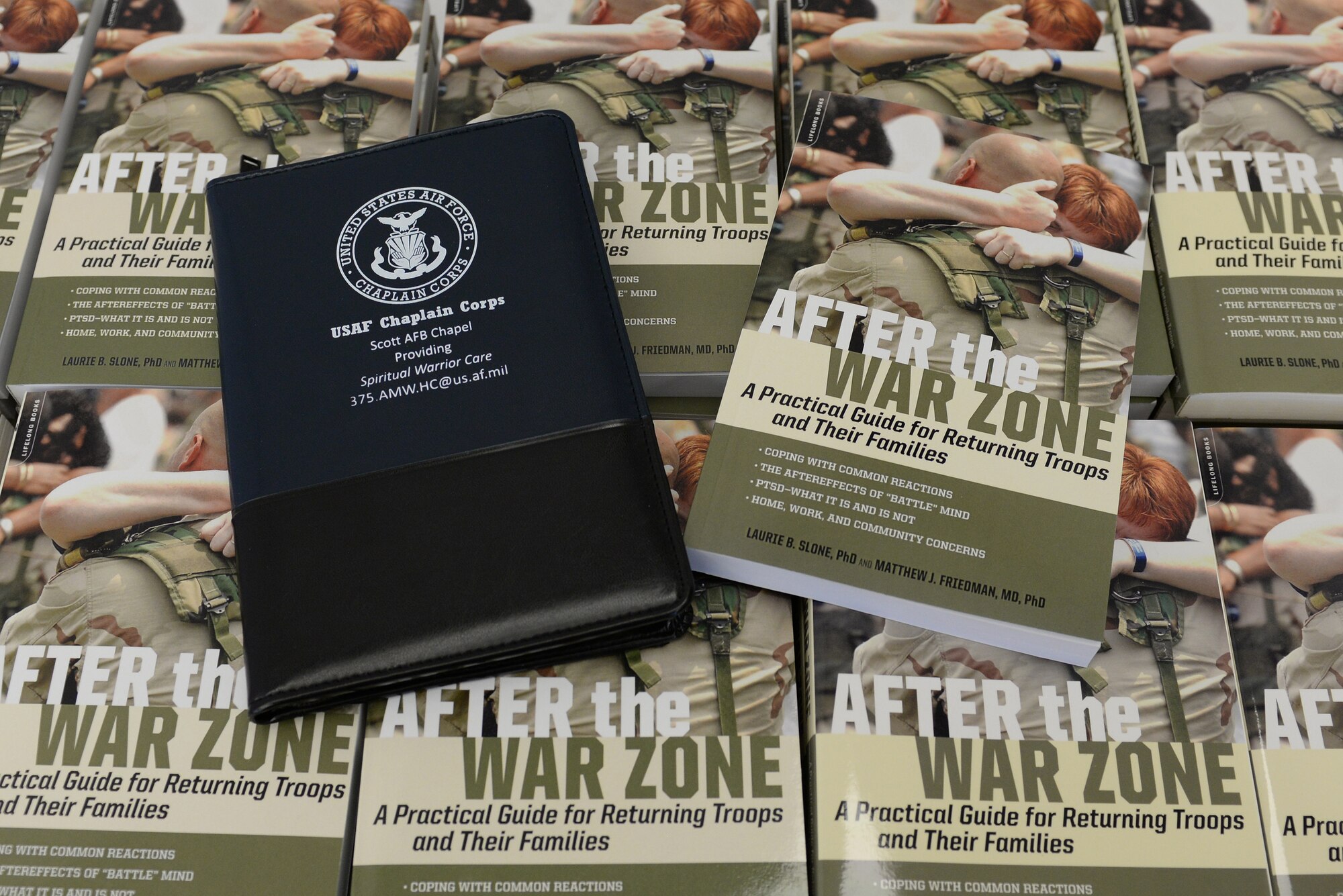 Community faith leaders attending the annual Faith Leadership Luncheon at Scott Air Force Base, Illinois on March 3, 2015 each recieved a book and note pad to help them better understand the specific needs of military families. The note pad contained a list of on base helping agencies, available to all military members on Team Scott. (U.S. Air Force photo by Senior Airman Sarah Hall-Kirchner)