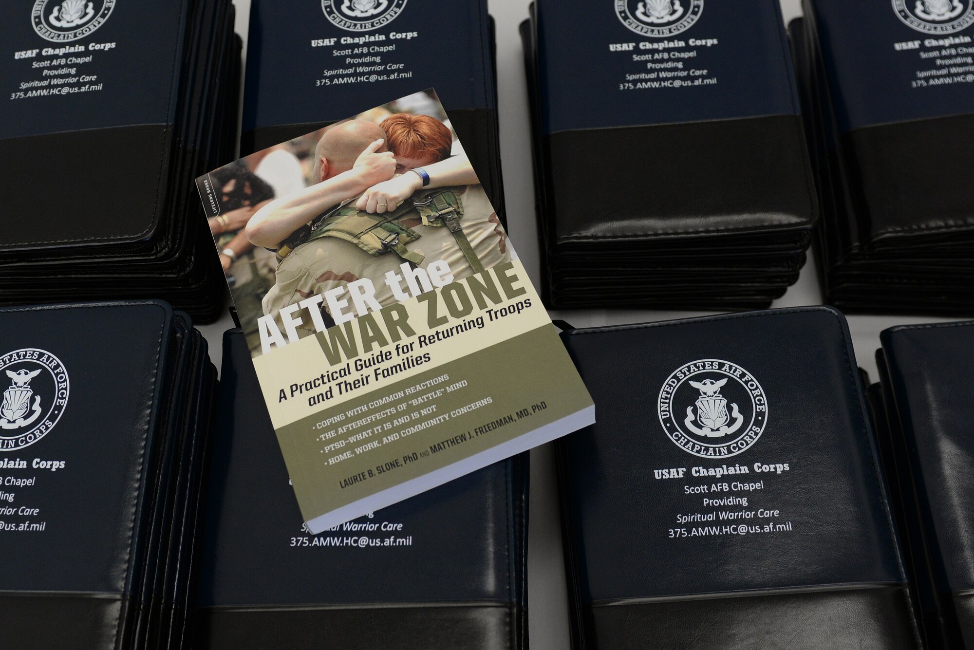 Community faith leaders attending the annual Faith Leadership Luncheon at Scott Air Force Base, Illinois on March 3, 2015 each recieved a book and note pad to help them better understand the specific needs of military families. The note pad contained a list of on base helping agencies, available to all military members on Team Scott. (U.S. Air Force photo by Senior Airman Sarah Hall-Kirchner)
