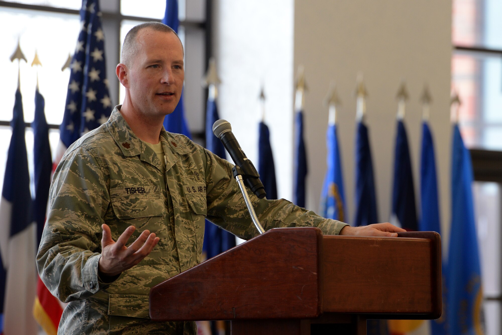 Maj. Erik Tisher, 375th Air Mobility Wing Chaplain, speaks to community faith leaders at the annual Faith Leadership Luncheon at Scott Air Force Base, Illinois on March 3, 2015. The goal of the luncheon is to reach out to community faith leaders and to teach them about the unique challenges facing military families. (U.S. Air Force photo by Senior Airman Sarah Hall-Kirchner)