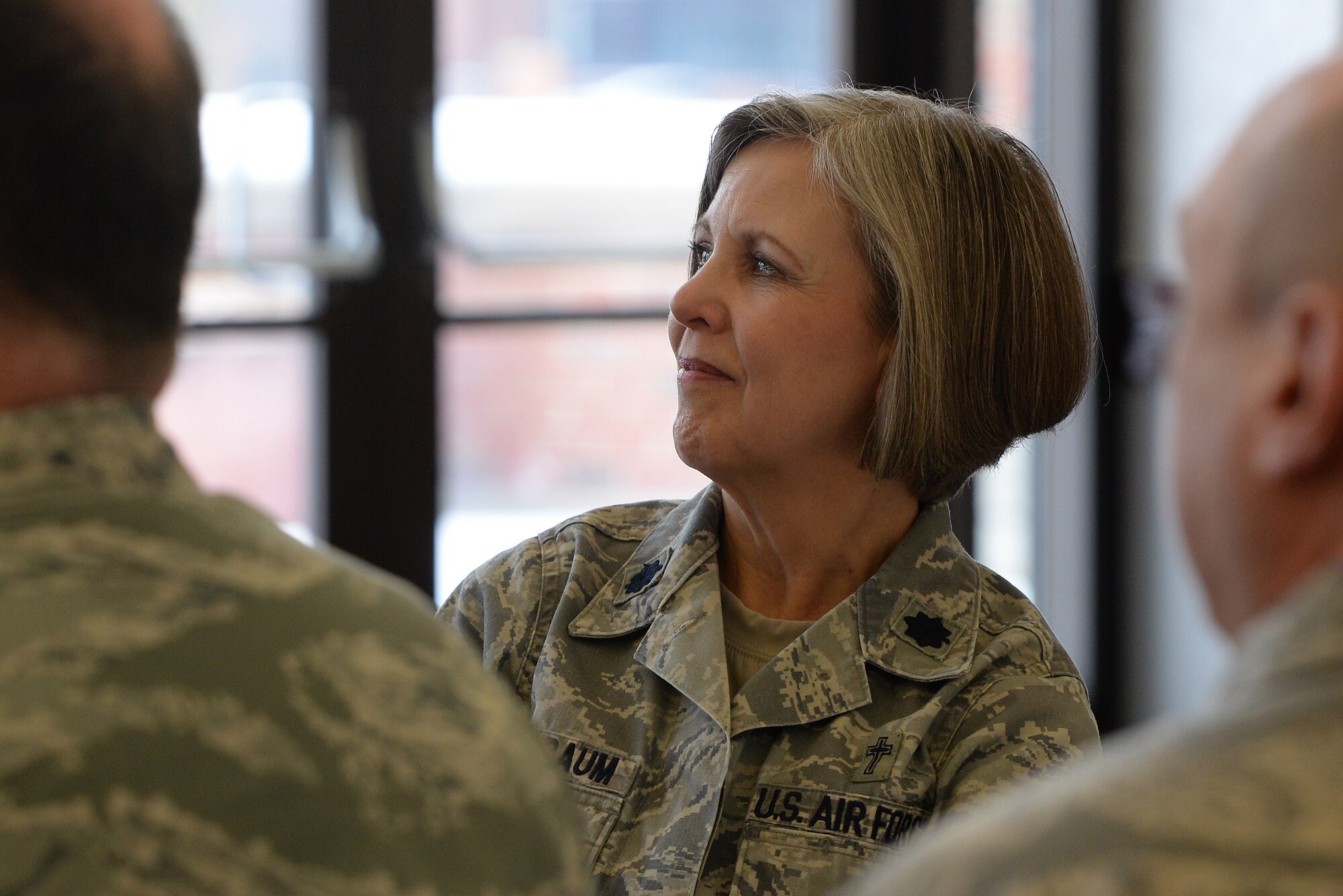 Lt. Col. Christine Blice-Baum, 375th Air Mobility Wing Chaplain, listens to a speaker during the annual Faith Leadership Luncheon at Scott Air Force Base, Illinois on March 3, 2015. The luncheon aims to educate community faith leaders on the unique challenges that military families face. (U.S. Air Force photo by Senior Airman Sarah Hall-Kirchner/Released)