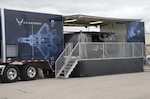 Capt. Jacob Chisolm, Air Force Recruiting Service chief, Air Force National Events Branch, and Master Sgt. Chad Tanner, Air Force Recruiting Service event marketing superintendent, let people out of the Rapid Strike simulator March 10 at Joint Base San Antonio-Randolph. The Rapid Strike is a full-motion simulator ride experience that immerses visitors in the high-tech world of the U.S. Air Force. Visitors board a ride that lets them experience a real Air Force mission including an F-22 flight, C-17 cargo drop, special operations ground surveillance, satellite communications, and a Reaper missile strike – all from a first person point-of-view.  (U.S. Air Force photo by Johnny Saldivar)