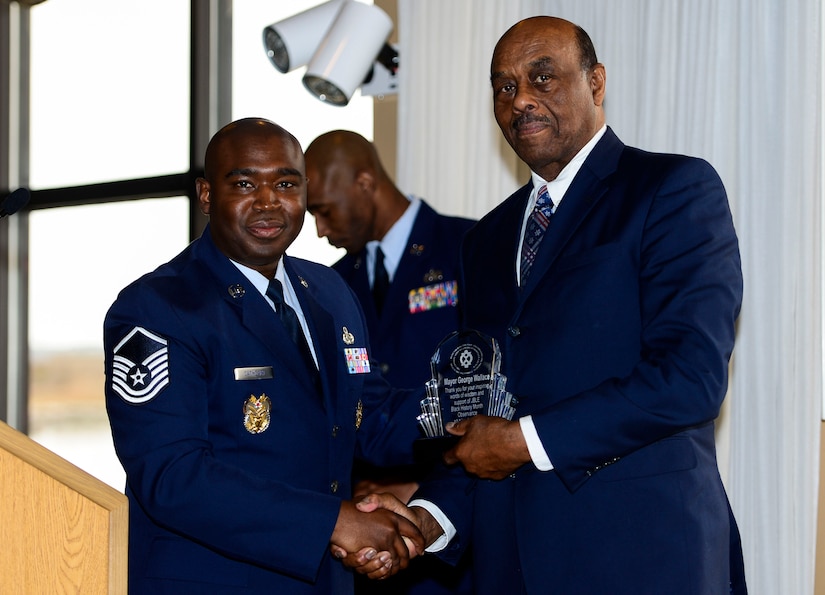U.S. Air Force Master Sgt. Rodney Cathcart, Langley African American Heritage Council president, presents George Wallace, Hampton mayor, with a token of appreciation during a Black History Month luncheon at Langley Air Force Base, Va., March 10, 2015. Wallace, who began his term in 2014, spoke to the crowd about the importance of BHM. (U.S. Air Force photo by Senior Airman Kayla Newman/Released)