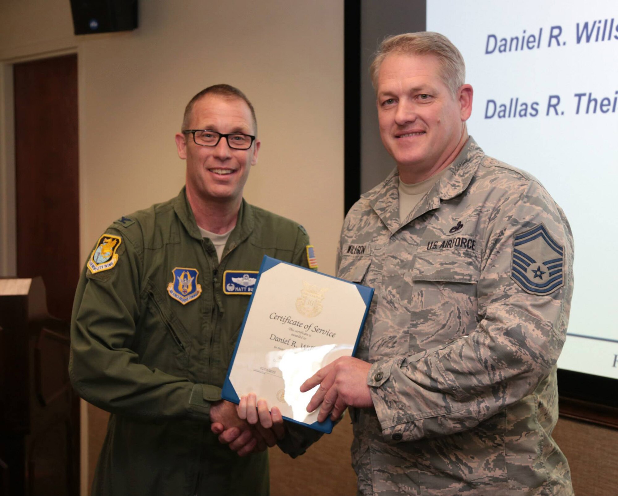 TRAVIS AIR FORCE BASE, Calif. -- Col. Matthew Burger, commander of the 349th Air Mobility Wing, recognizes Senior Master Sgt. Daniel Wilson at the wing pre-Unit Training Assembly staff meeting, March 6, 2015, at Travis Air Force Base, Calif. Wilson has faithfully served 30 years of federal service. (U.S. Air Force photo/Lt. Col. Robert Couse-Baker/Released)
