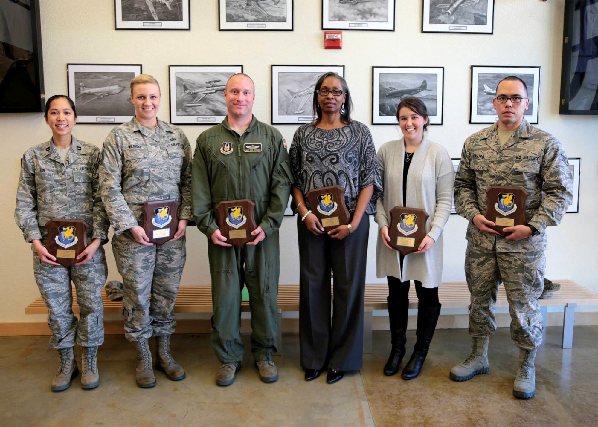 TRAVIS AIR FORCE BASE, Calif. -- The 349th Air Mobility Wing's 1st quarter award winners pose for a photo in the wing's Heritage Hall March 6, 2015, at Travis Air Force Base, Calif. From Left: Company Grade Officer of the Quarter, Capt. Raychaelle Blue; Noncommissioned Officer of the Quarter, Tech. Sgt. Jeanette Wilinski; Senior Noncommissioned Officer of the Quarter, Master Sgt. Kristopher Stevens; Civilian of the Quarter Category I, Ms. Joyce Hayes; Civilian of the Category Category II, Ms. Brittney Cipolla; Honor Guardsman of the Quarter, Airman 1st Class, Manuel Castro. Airman of the Quarter, Senior Airman Kevin Brown, was not available for the photo. (U.S. Air Force photo/Lt. Col. Robert Couse-Baker/Released)