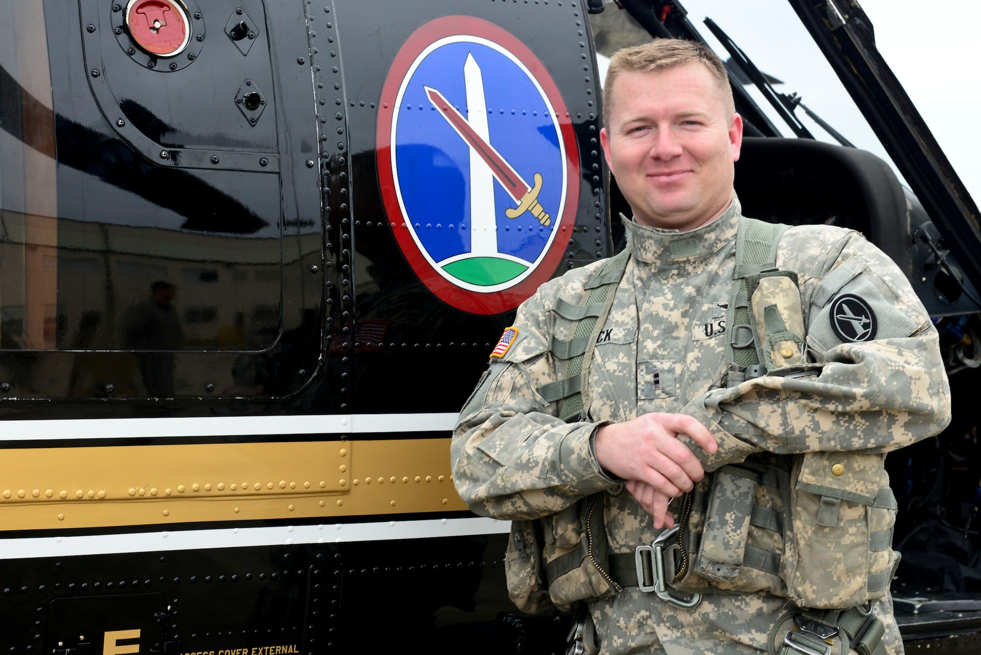 U.S. Army Chief Warrant Officer 2 Michael Beck, Charlie Company, 12th Aviation Battalion pilot, stands in front of a VH-60 Blackhawk helicopter after its final flight to Fort Eustis, Va., March 10, 2015. The retired helicopter was used as a form of transportation for VIPs including the Chairman of the Joint Chiefs of Staff and is set to become a display at the U.S. Army Transportation Museum. (U.S. Air Force photo by Senior Airman Kimberly Nagle/Released)