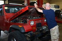 Retired U.S. Air Force Master Sgt. Reagan Ross, a local mechanic, closes the hood of his vehicle in the Auto Hobby Shop March 10, 2015, at Moody Air Force Base, Ga. Ross said he likes to use the shop because it’s an affordable way to work on his personal car. (U.S. Air Force photo by Airman 1st Class Kathleen D. Bryant)