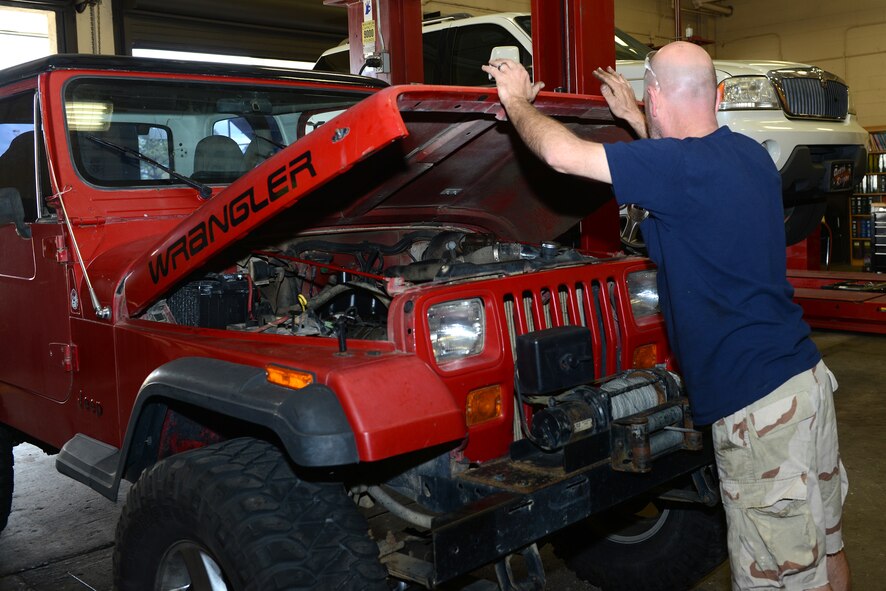 Retired U.S. Air Force Master Sgt. Reagan Ross, a local mechanic, closes the hood of his vehicle in the Auto Hobby Shop March 10, 2015, at Moody Air Force Base, Ga. Ross said he likes to use the shop because it’s an affordable way to work on his personal car. (U.S. Air Force photo by Airman 1st Class Kathleen D. Bryant)