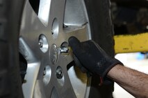 Retired U.S. Air Force Master Sgt. Reagan Ross, a local mechanic, tightens lug nuts on his vehicle in the Auto Hobby Shop March 10, 2015, at Moody Air Force Base, Ga. Team Moody members have the option of do-it-yourself services by renting auto stall bays hourly. (U.S. Air Force photo by Airman 1st Class Kathleen D. Bryant/Released)