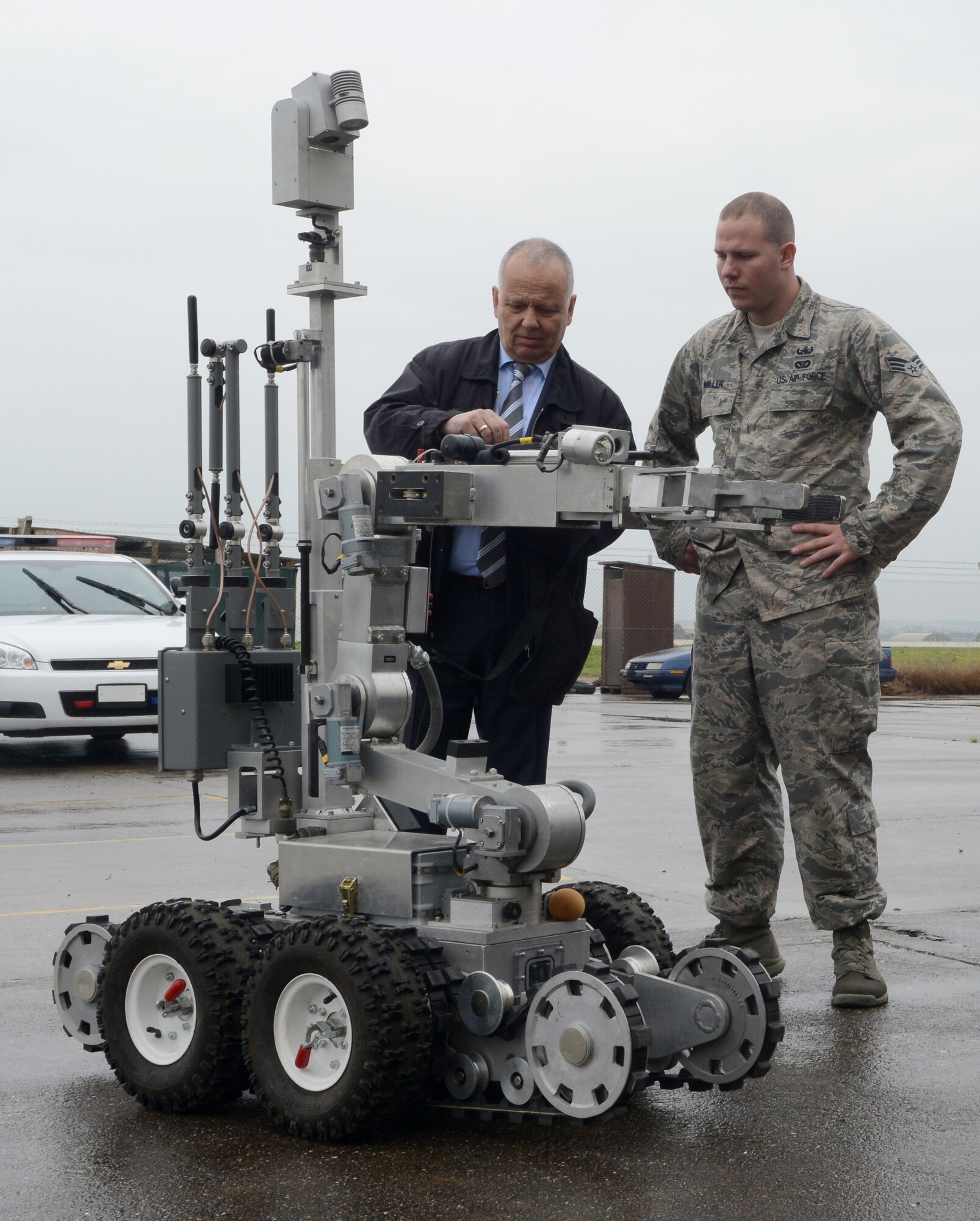 Senior Airman Brandon Miller, 39th Civil Engineer Squadron Explosive Ordinance Disposal technician, assists Robert Hochbaum, German NATO parliamentary assembly member, operate an unmanned remote robot March 11, 2015, at Incirlik Air Base, Turkey. One of the many stops during the NATO parliamentary assembly and their staff visit included EOD and military working dogs demonstrations. (U.S. Air Force photo by Staff Sgt. Caleb Pierce/Released)