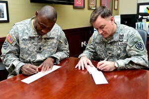 U.S. Army Col. William Galbraith, 733rd Mission Support Group commander, and Sgt. Maj. James Jackson, 733rd MSG command sergeant major, fill out donation forms for the 2015 Army Emergency Relief Campaign at Fort Eustis, Va., March 9, 2015. AER is a private, nonprofit organization and is an Army-wide emergency financial assistance organization. The AER at Fort Eustis provides emergency monetary funds to Soldiers and retirees in need throughout the year. The campaign began March 9, and will end May 22. (U.S. Air Force photo by Senior Airman Kimberly Nagle/Released)


