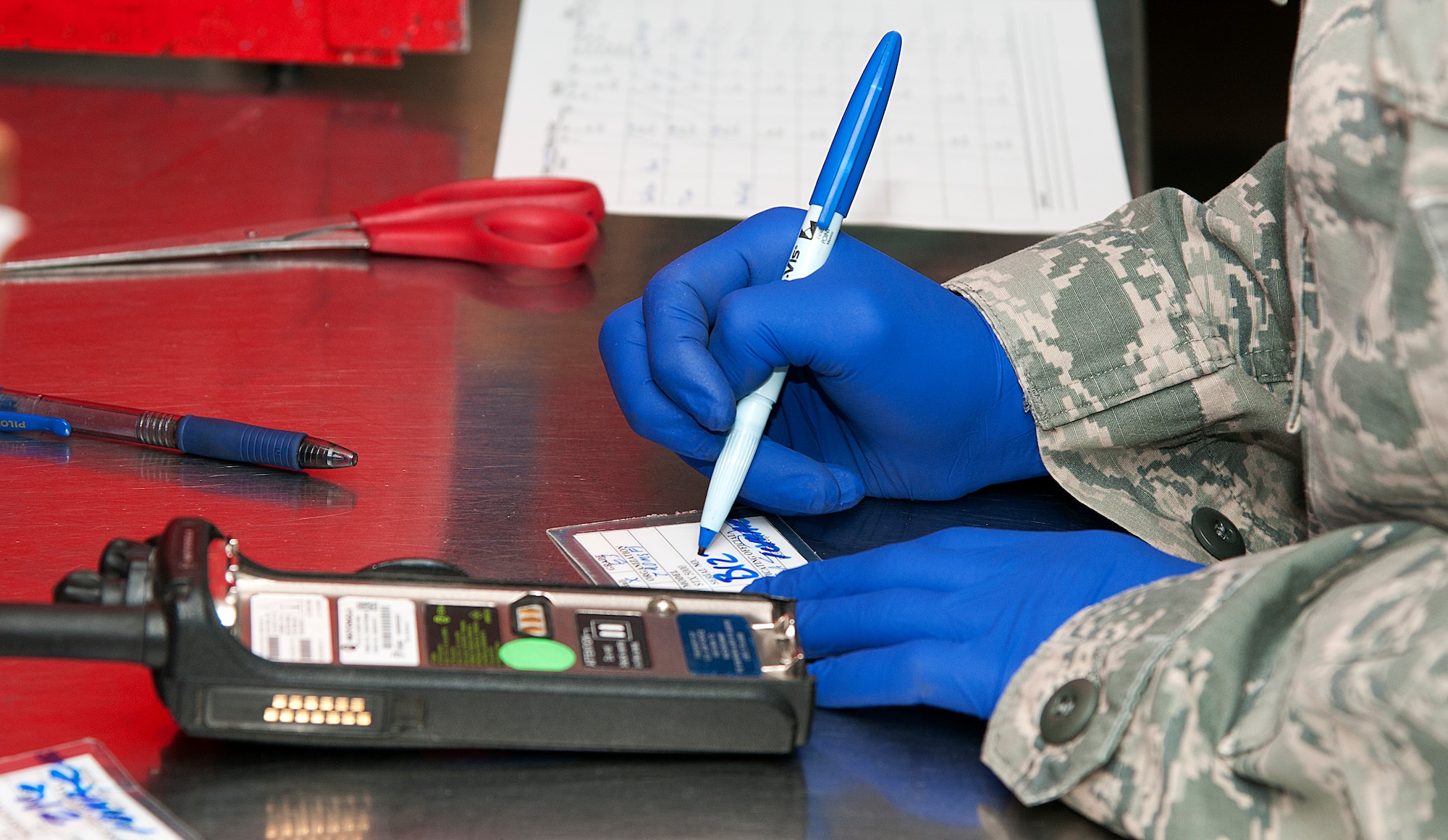 Senior Airman William Young, 90th Security Forces Group armorer, writes the serial number of a radio onto an inventory card March 10, 2015, in the 90th SFG armory, F.E. Warren Air Force Base, Wyo. Every piece of gear handed out to SFG defenders must be documented on an inventory card. (U.S. Air Force photo by Airman 1st Class Brandon Valle)  