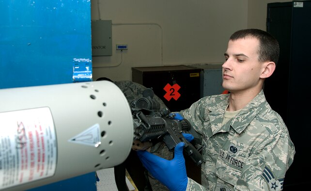 Senior Airman William Young, 90th Security Forces Group armorer, checks to make sure an M4 rifle is clear before issuing it to a defender March 10, 2015, in the 90th SFG armory, F.E. Warren Air Force Base, Wyo. Armorers check each weapon they issue to ensure they are safe to hand out. (U.S. Air Force photo by Airman 1st Class Brandon Valle)   