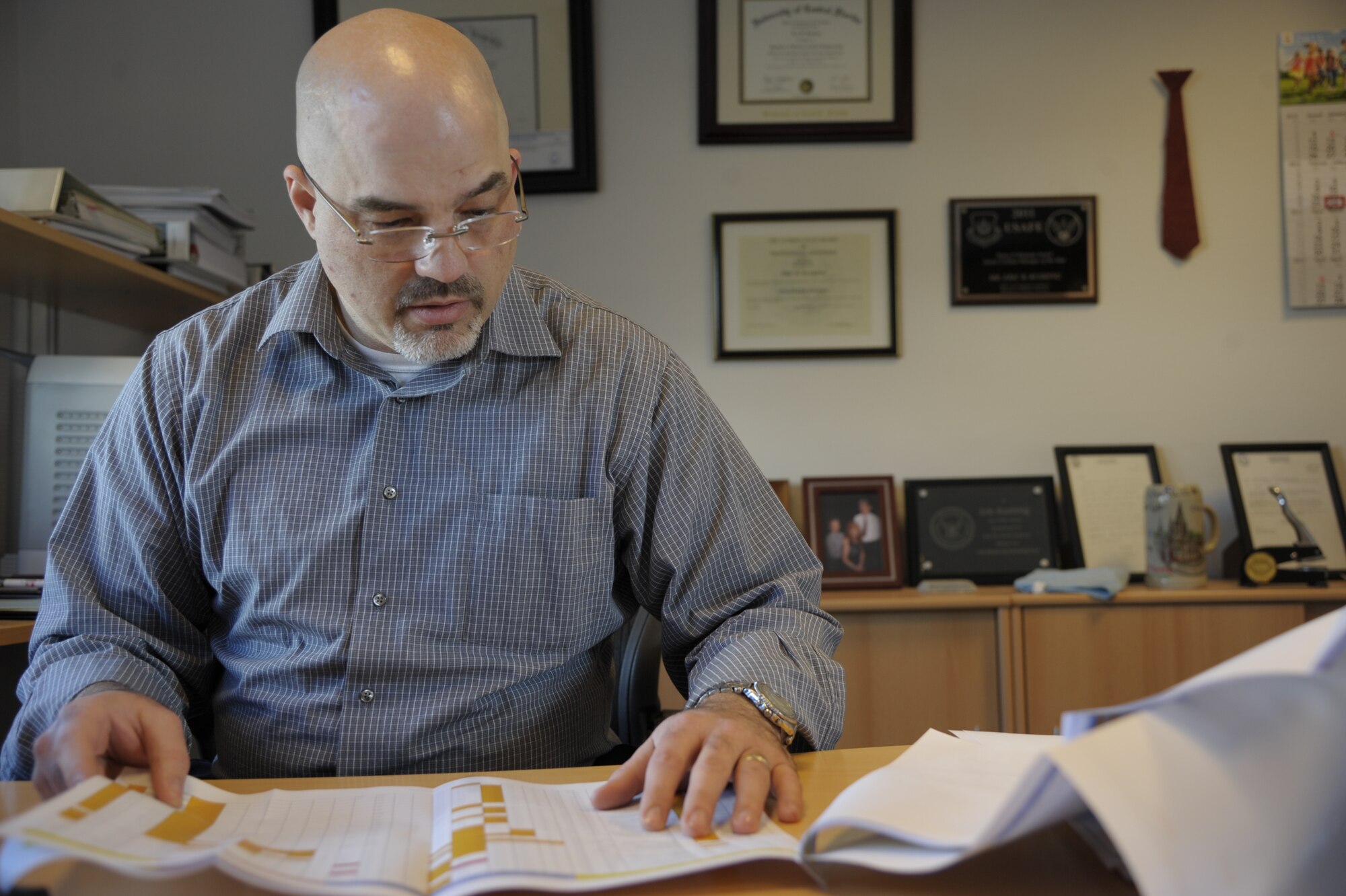 Eric Rushing, 86th Civil Engineer Squadron chief of engineering, looks over the list of projects currently being worked at Ramstein Air Base, Germany, March 5, 2015. Rushing won the Harry P. Rietman Award (Senior Civilian Manager) for his work throughout 2014, which included the execution of more than 350 projects in the Kaiserslautern Military Community. (U.S. Air Force photo/Senior Airman Timothy Moore)