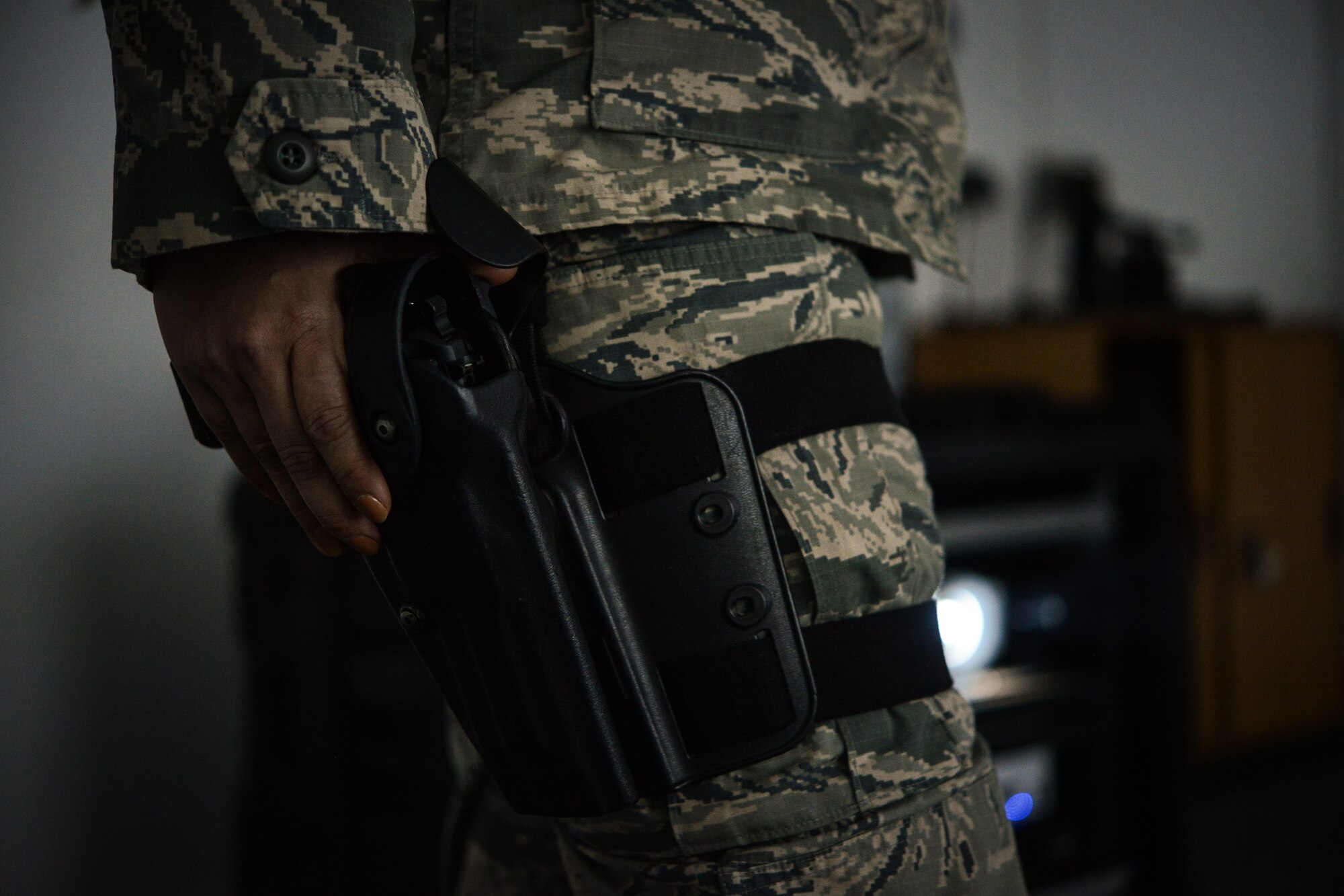 An Airman assigned to the 86th Security Forces Squadron grips her air compressed weapon before a use of force training exercise. Defenders arriving at Ramstein must complete this annual training in order to stay armed. The training course is comprised of three components which include a classroom portion, a written exam and a virtual test on the firearms training system. (U.S. Air Force photo/Senior Airman Nicole Sikorski)