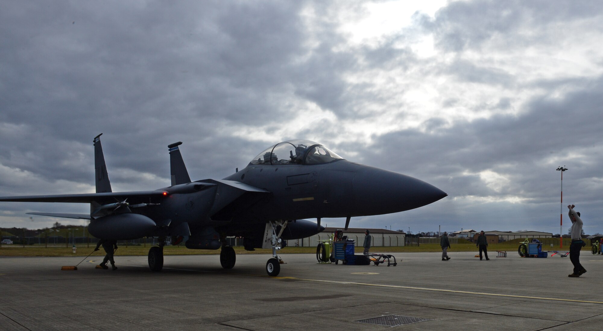 Airman 1st Class Tyler Burk, 492nd Aircraft Maintenance Unit assistant dedicated crew chief, marshals an F-15E Strike Eagle to a stop at Royal Air Force Lakenheath, England, March 5, 2015. The 48th Fighter Wing not only exceeded the wing’s flying goal, but also beat the Air Force standard, flying 594 F-15E Strike Eagle training flights, also known as sorties, for the month of February.  (U.S. Air Force photo by Airman 1st Class Erin R. Babis/Released)
