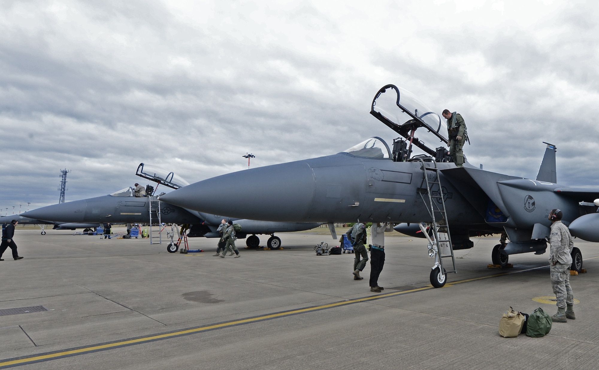 Aircrew and maintainers work together on the flightline after a combat training flight at Royal Air Force Lakenheath, England, March 5, 2015. The 48th Fighter Wing not only exceeded the wing’s flying goal, but also beat the Air Force standard, flying 594 F-15E Strike Eagle combat training flights, also known as sorties, for the month of February. (U.S. Air Force photo by Airman 1st Class Erin R. Babis/Released)
