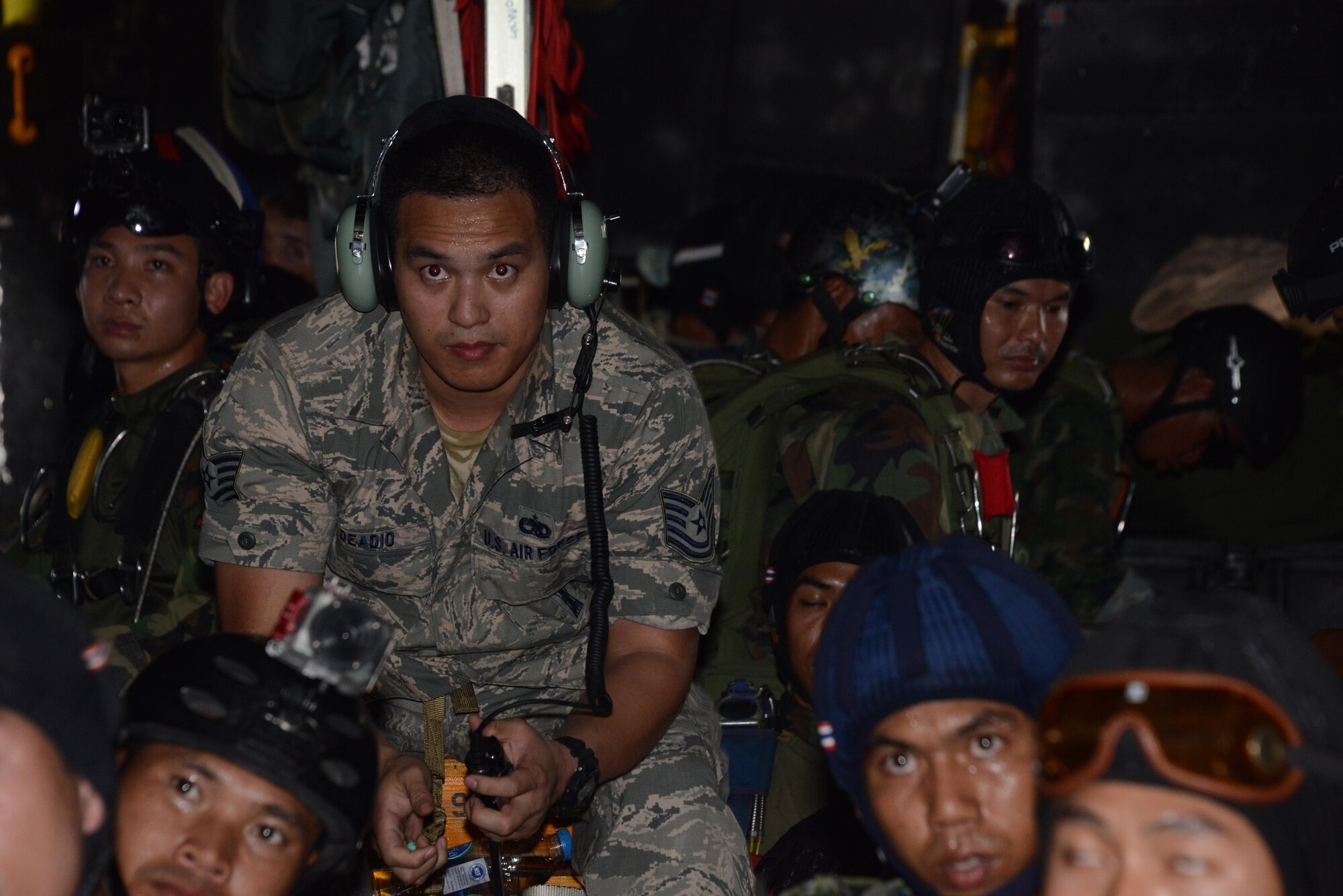 Second from left, Tech. Sgt. Edward Deadio, 31st Munitions Squadron, helps translate between the U.S. military and the Thai military during a jump briefing Feb. 16, 2015. Deadio, a native Thai speaker and participant in the Language Enabled Airman Program, was sent to Cobra Gold 15-1 to provide language support for the 353rd Special Operations Group. During the 2-week exercise, Deadio helped bridge the language and culture gap between U. S. and Thai military. (U.S. Air Force photo by Tech. Sgt. Kristine Dreyer)
