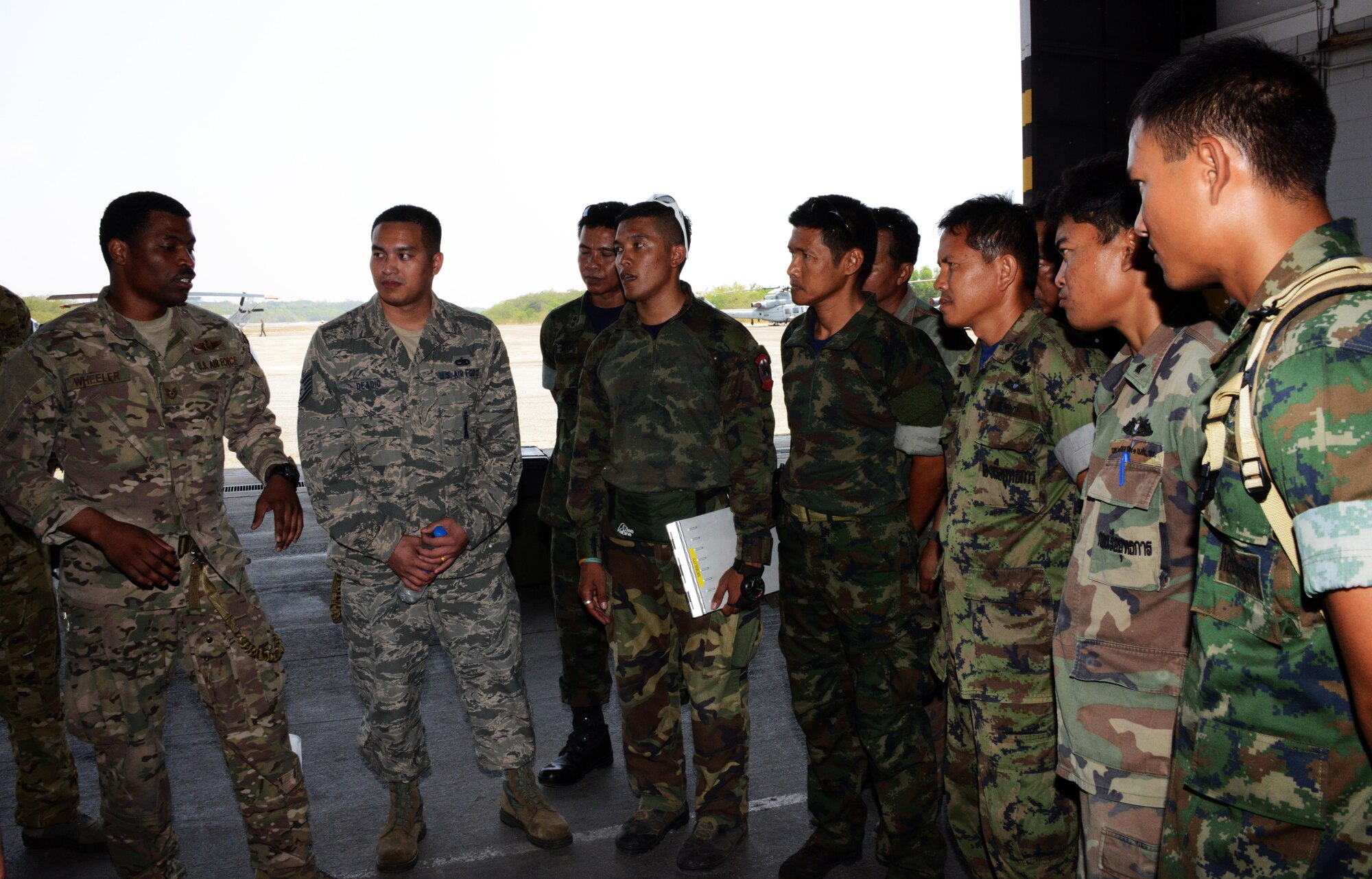 Second from left, Tech. Sgt. Edward Deadio, 31st Munitions Squadron, helps translate between the U.S. military and the Thai military during a jump briefing Feb. 16, 2015. Deadio, a native Thai speaker and participant in the Language Enabled Airman Program, was sent to Cobra Gold 15-1 to provide language support for the 353rd Special Operations Group. During the 2-week exercise, Deadio helped bridge the language and culture gap between U. S. and Thai military. (U.S. Air Force photo by Tech. Sgt. Kristine Dreyer)