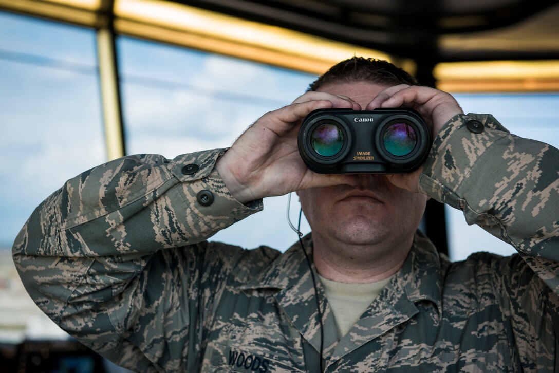 Senior Airman Richard Woods, 39th Operations Support Squadron watch tower supervisor, checks incoming aircrafts landing gear during their approach March 2, 2015, at Incirlik Air Base, Turkey. Woods inspects every incoming aircrafts landing gear to ensure it is lowered properly for a safe and controlled landing. (U.S. Air Force photo by Airman Cory W. Bush/Released)