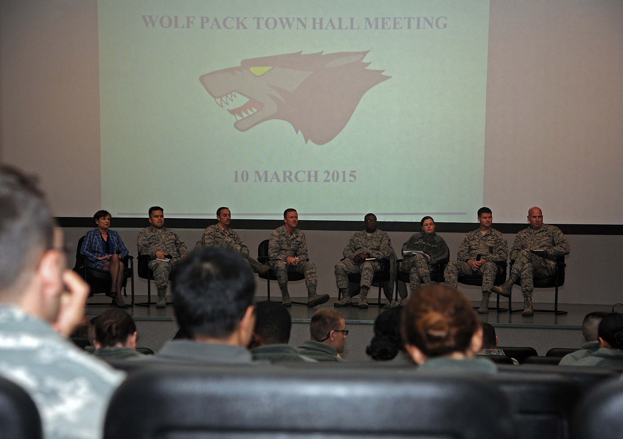 Col. Ken “Wolf” Ekman, 8th Fighter Wing commander, receives a question from an audience member at the Wolf Pack town hall meeting at Kunsan Air Base, Republic of Korea, Mar. 10, 2015. Wolf was joined on stage by an eight-member panel of wing leadership to meet with Airmen and discuss their concerns. (U.S. Air Force photo by Senior Airman Divine Cox/Released)