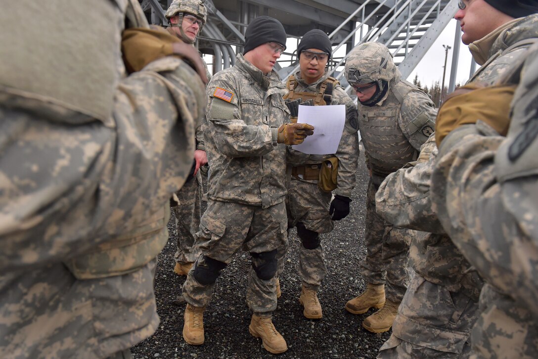 Army 1st Lt. Tyler Sinisgalli, center, briefs soldiers during M249 Squad Automatic Weapon qualification at Grezelka range on Joint Base Elmendorf-Richardson, Alaska, March 3, 2015. Sinisgalli is assigned to the 25th Infantry Division's Company A, 501st Infantry Regiment, 4th Infantry Brigade Combat Team Airborne, Alaska. The M249 is an American adaptation of a Belgian light machine gun that has been used in every major conflict involving the United States since the U.S. invasion of Panama in 1989.