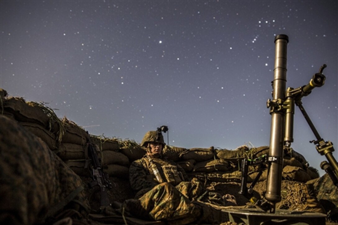 U.S. Marine Lance Cpl. Griffin Forrester stands watch from a fighting hole during amphibious squadron and Marine expeditionary unit integration training in Camp Pendleton, Calif., March 6, 2015.  