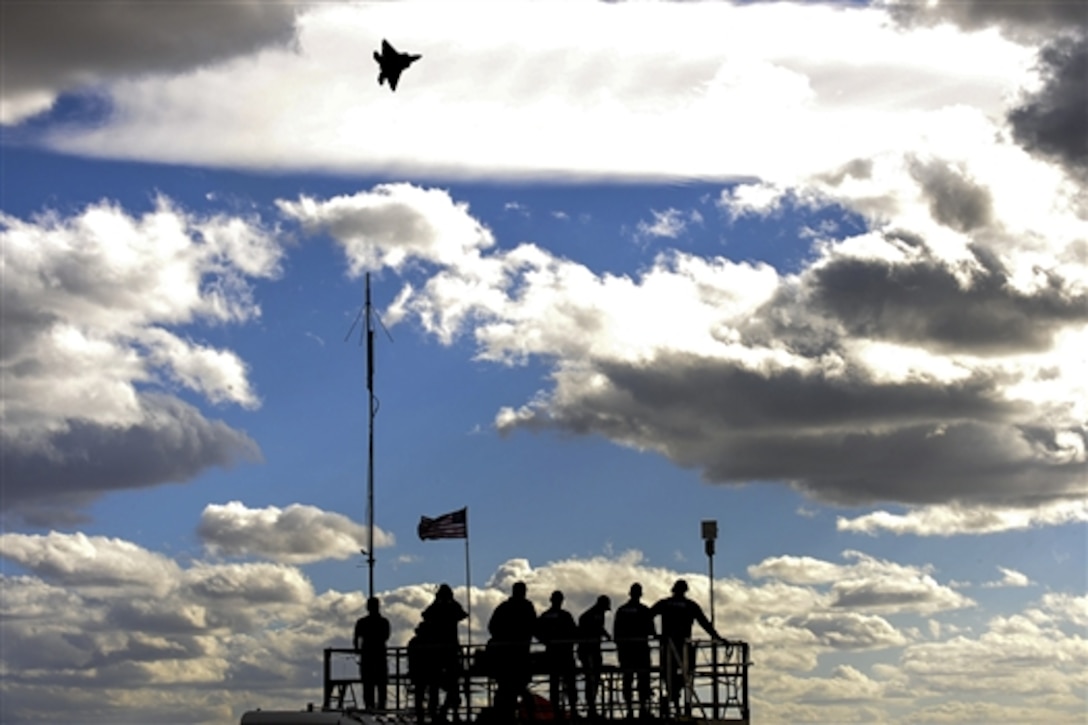 An F-22 Raptor soars above spectators during the 2015 Heritage Flight Training and Certification Course on Davis-Monthan Air Force Base, Ariz., Feb. 28, 2015.  