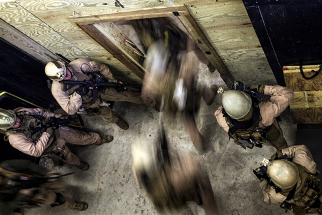 A Marine fire team enters a room after throwing in a flash bang during a close-quarters tactics training event at Stone Bay on Marine Corps Base Camp Lejeune, N.C., March 6, 2015. The Marines are assigned to the 2nd Force Reconnaissance Detachment 6.  
