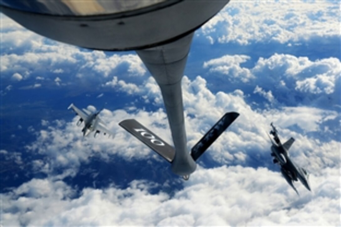 F-16 Fighting Falcons perform maneuvers after receiving fuel from a KC-135 Stratotanker over southern France during Exercise Iron Hand, March 4, 2015. The F-16s are assigned to the 31st Fighter Wing, based at Aviano Air Base, Italy, and the KC-135 is assigned to the 100th Air Refueling Wing, based at RAF Mildenhall, England.
