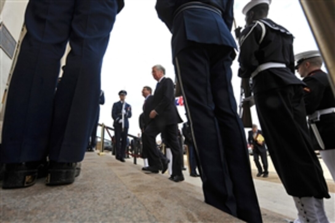 British Defense Secretary Michael C. Fallon, center front, and U.S. Secretary of Defense Ash Carter walk through an honor cordon at the Pentagon, March 11, 2015. Both leaders met to discuss defense matters of mutual concern.