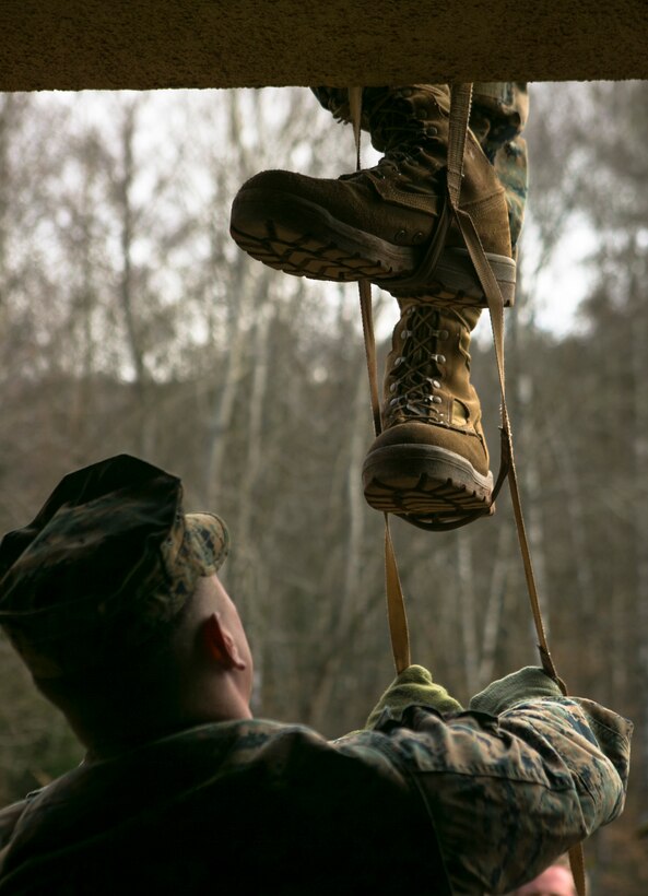 A U.S. Marine with Special-Purpose Marine Air-Ground Task Force Crisis Response-Africa stabilizes a portable ladder during an urban obstacle course run by U.S. Army Special Forces in Baumholder, Germany, March 5, 2015. The course prepared the Marines to use minimal equipment to conquer complex urban environments. (U.S. Marine Corps photo by Sgt. Paul Peterson/Released)