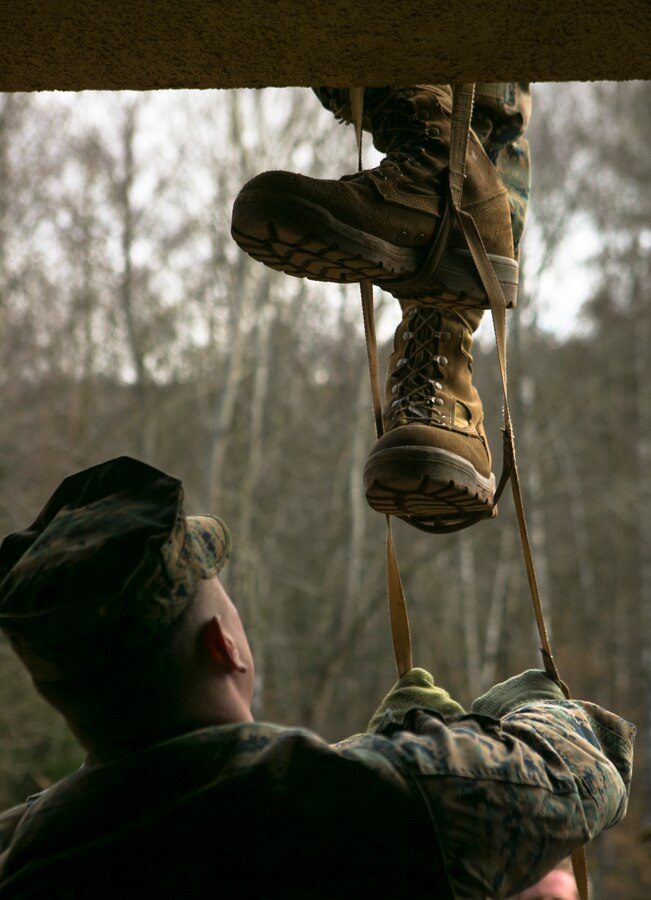 A U.S. Marine with Special-Purpose Marine Air-Ground Task Force Crisis Response-Africa stabilizes a portable ladder during an urban obstacle course run by U.S. Army Special Forces in Baumholder, Germany, March 5, 2015. The course prepared the Marines to use minimal equipment to conquer complex urban environments. (U.S. Marine Corps photo by Sgt. Paul Peterson/Released)