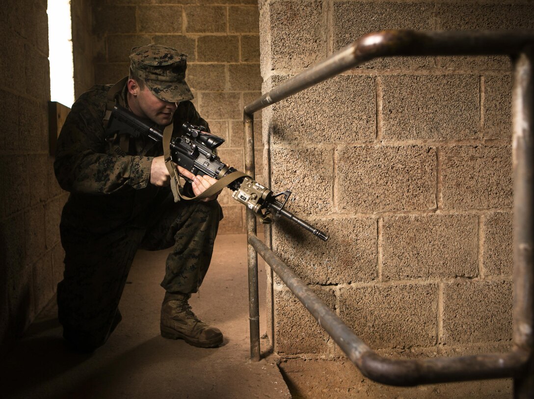 U.S. Marine Cpl. Matthew Duggan, with Special-Purpose Marine Air-Ground Task Force Crisis Response-Africa, provides security at a stairwell while conducting close-quarter battle drills with U.S. Army Special Forces in Baumholder, Germany, March 4, 2015. Special Forces personnel worked with the Marines to hone their ability to clear buildings and prepare the two groups for potential urban environment operations together. (U.S. Marine Corps photo by Sgt. Paul Peterson/Released)