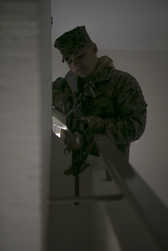 U.S. Marine Corps Lance Cpl. Christian Vasquez, with Special-Purpose Marine Air-Ground Task Force Crisis Response-Africa, provides security at a stairwell while conducting close-quarters battle drills with U.S. Army Special Forces in Baumholder, Germany, March 4, 2015. Special Forces personnel taught the Marines a variety of techniques to rapidly clear multistoried building and enhance the two groups’ interoperability for potential future operations. (U.S. Marine Corps photo by Sgt. Paul Peterson/Released)