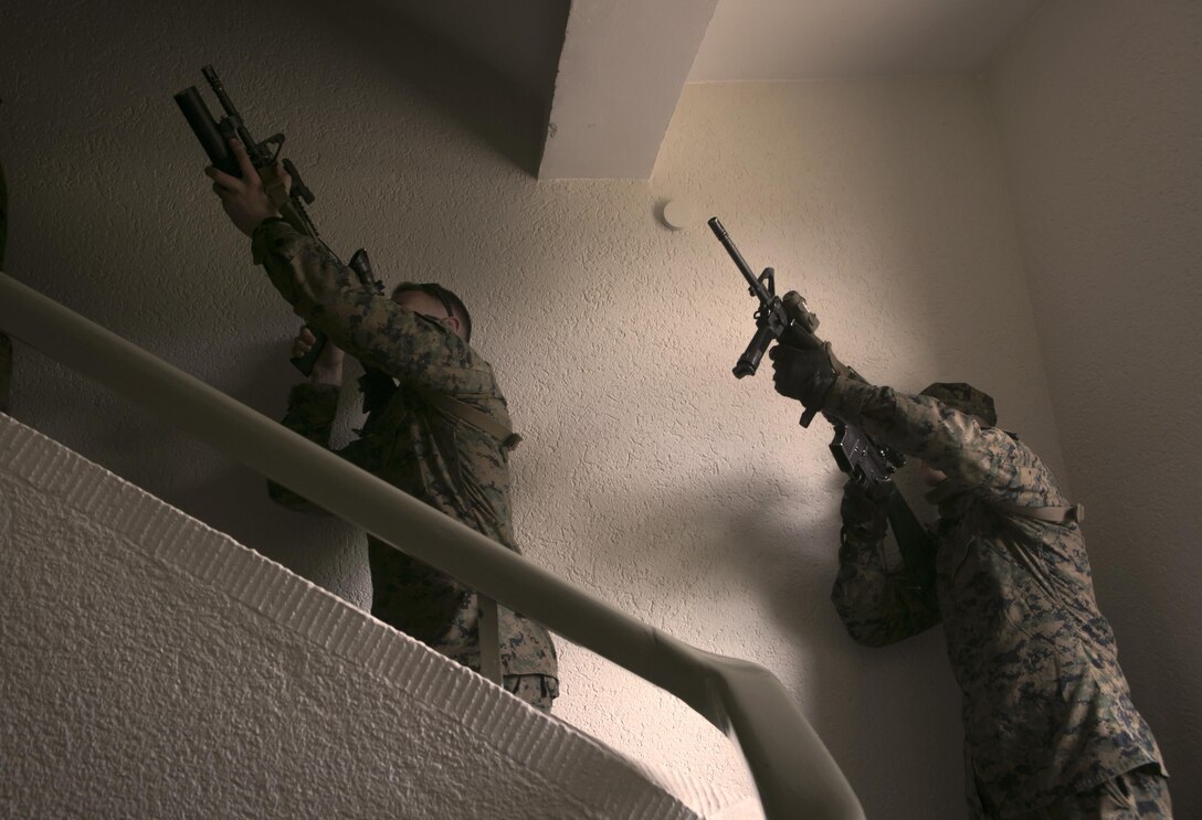 U.S. Marines with Special-Purpose Marine Air-Ground Task Force Crisis Response-Africa move up a stairwell while conducting close-quarters battle drills with U.S. Army Special Forces in Baumholder, Germany, March 4, 2015. The Marines worked with Special Forces personnel to develop their ability to rapidly clear buildings and enhance their ability to work as a team for potential future operations. (U.S. Marine Corps photo by Sgt. Paul Peterson/Released)