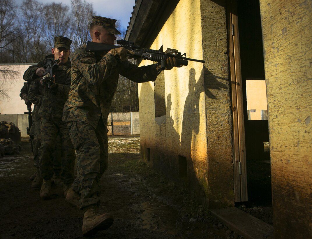 U.S. Marine Lance Cpl. Steven Watson, front, and Keaton Moore, with Special-Purpose Marine Air-Ground Task Force Crisis Response-Africa, rush into a house while conducting close-quarters battle drills with U.S. Army Special Forces in Baumholder, Germany, March 4, 2015. The two Marines moved inside the structure and worked as a team to clear a series of rooms. (U.S. Marine Corps photo by Sgt. Paul Peterson/Released)