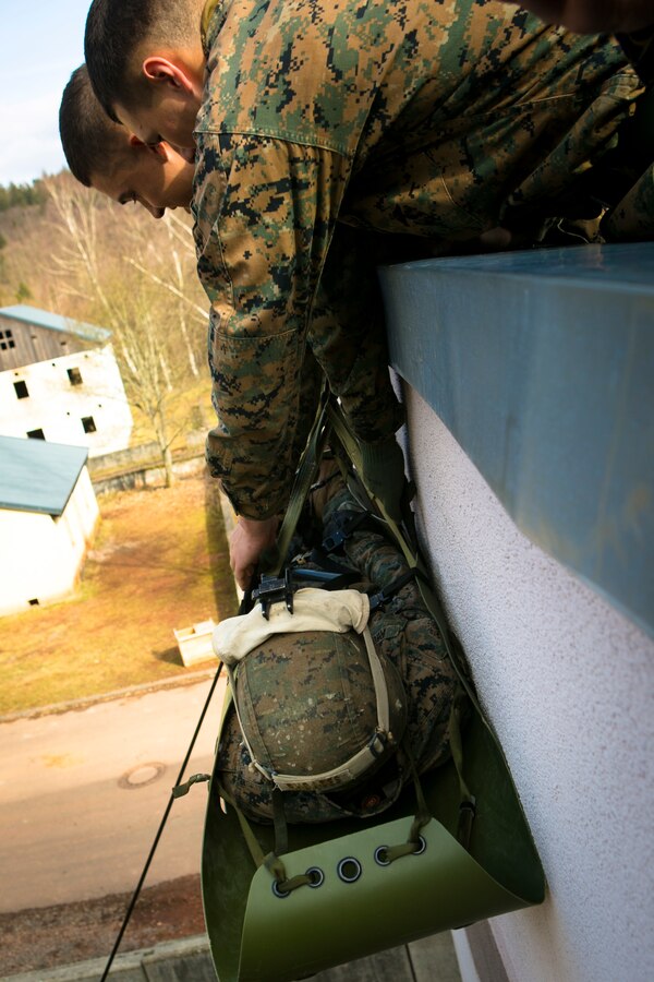 U.S. Marines with Special-Purpose Marine Air-Ground Task Force Crisis Response-Africa lower a simulated casualty down the side of a building during a training exercise with U.S. Army Special Forces in Baumholder, Germany, March 6, 2015. The light weight, collapsible sled allows Marines to efficiently move casualties in urban environments. (U.S. Marine Corps photo by Sgt. Paul Peterson/Released)