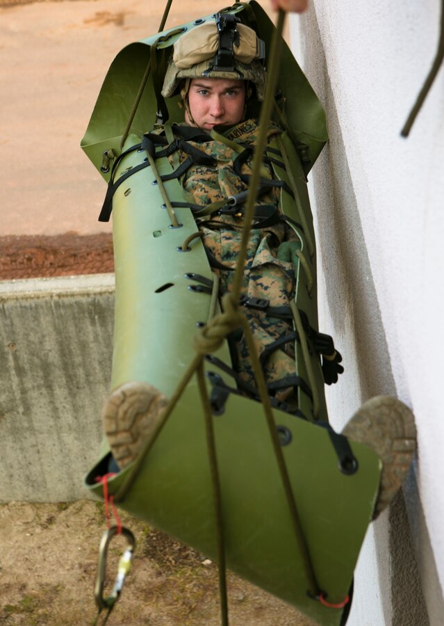 U.S. Marines lower Lance Cpl. Trevor Grames, with Special-Purpose Marine Air-Ground Task Force Crisis Response-Africa, down the side of a building in a casualty sled during a training exercise with U.S. Army Special Forces in Baumholder, Germany, March 6, 2015. The Marines lowered Grames two-stories using only the hand carried sled and ropes. (U.S. Marine Corps photo by Sgt. Paul Peterson/Released)